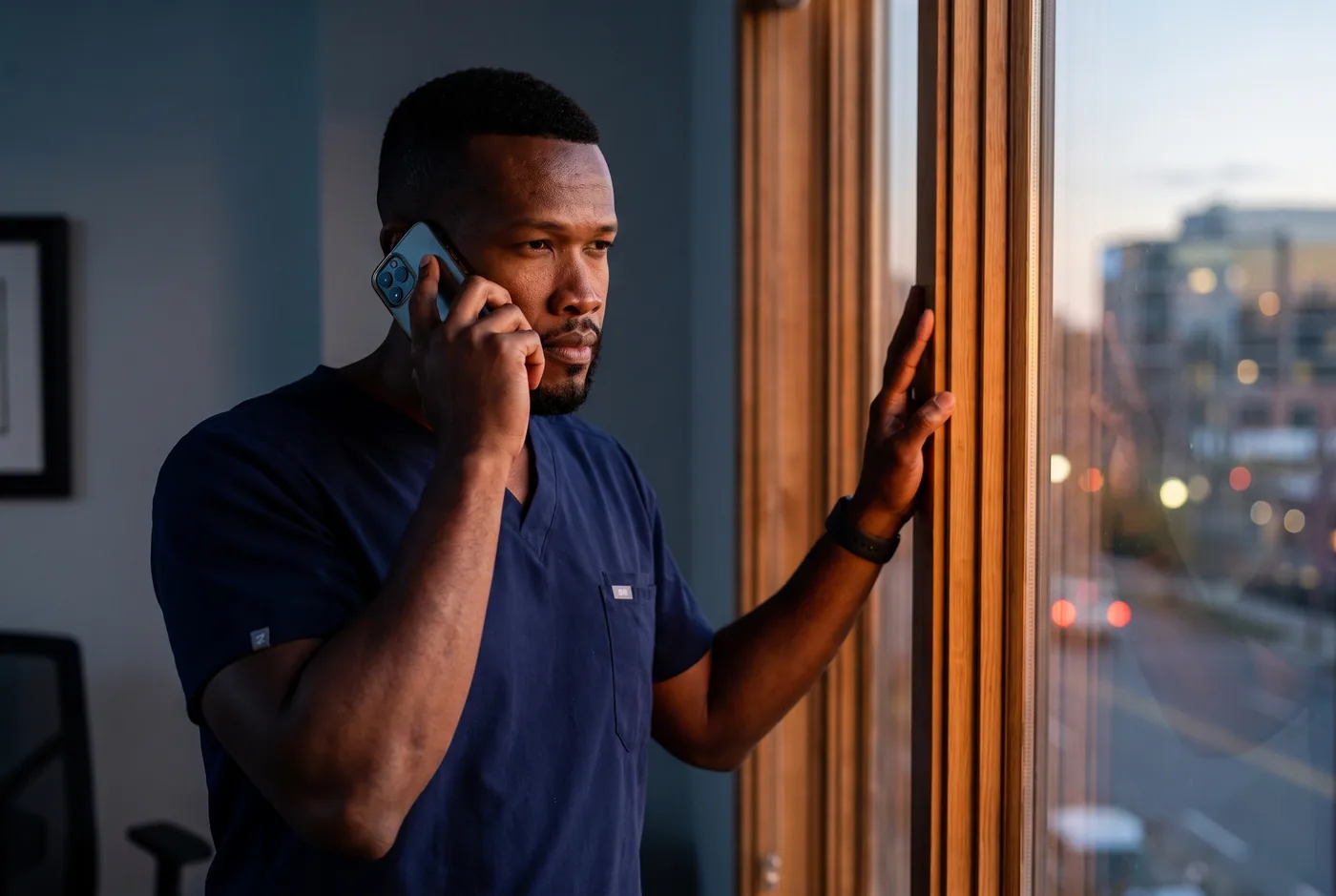 Dr. Peter K. Cudjoe on the telephone in a clinic office in the evening